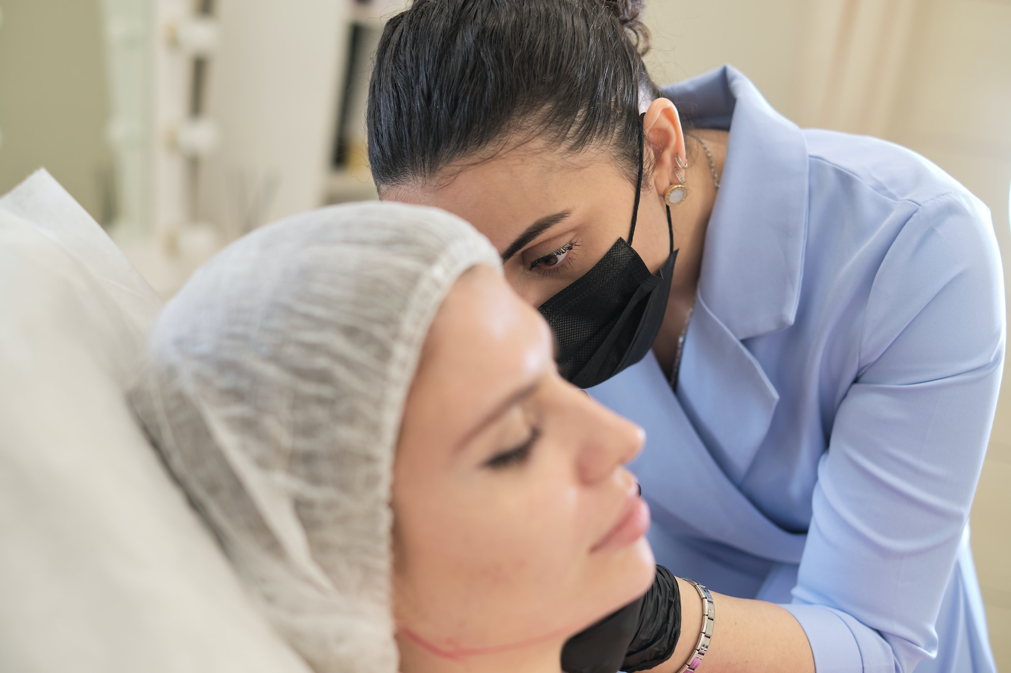 cosmetology clinic, where skilled aesthetician is seen injecting filler into jowls. procedure